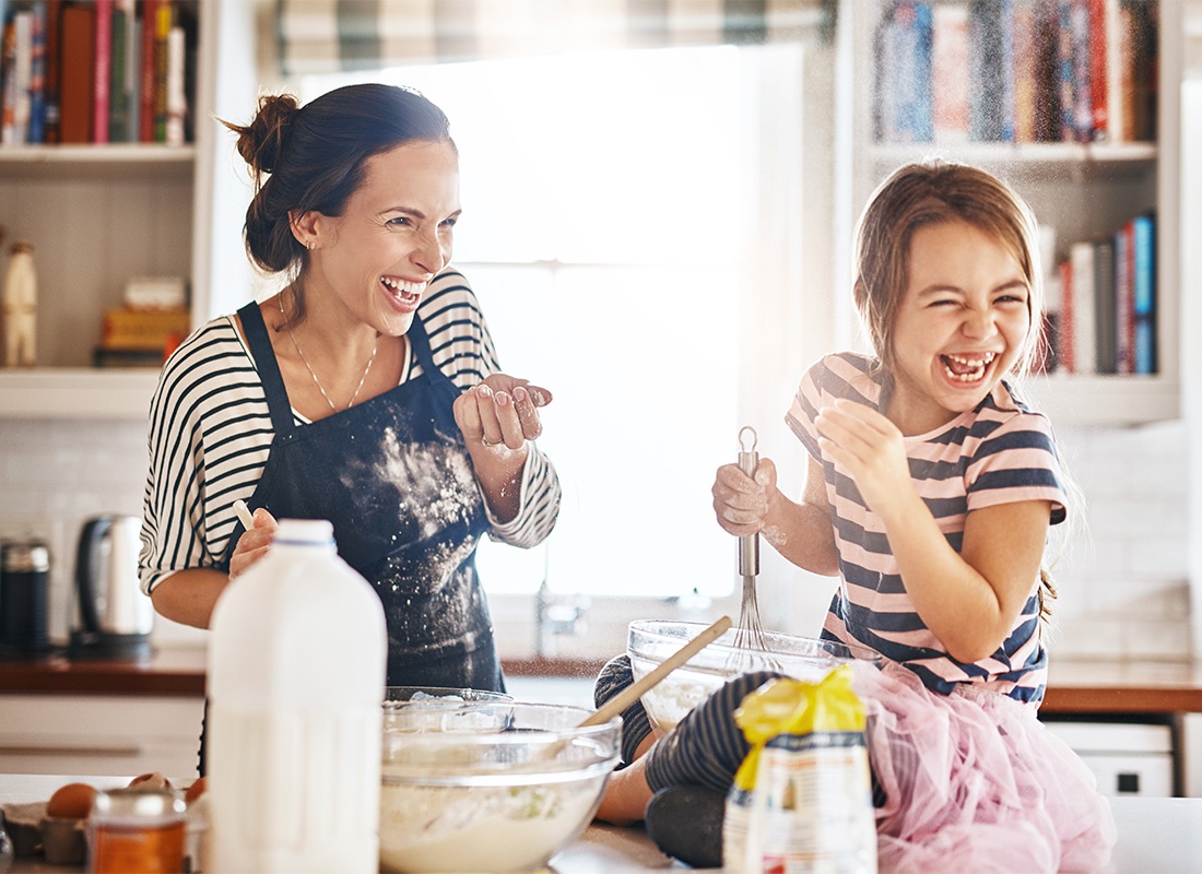 Read Our Reviews - Portrait of a Cheerful Mother and Daughter Having Fun Baking Together in the Kitchen