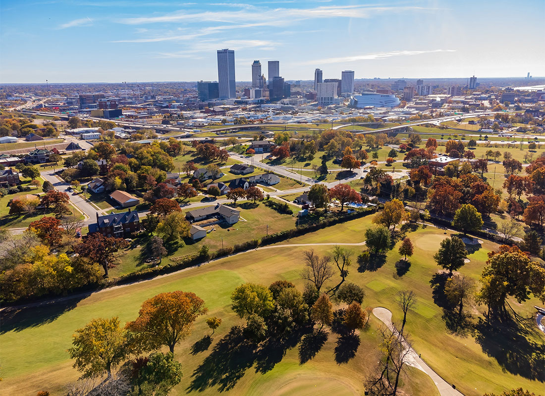 We Are Independent - Aerial View of a Park with Colorful Trees in Oklahoma with Views of Skyscrapers in the Distance on a Sunny Day